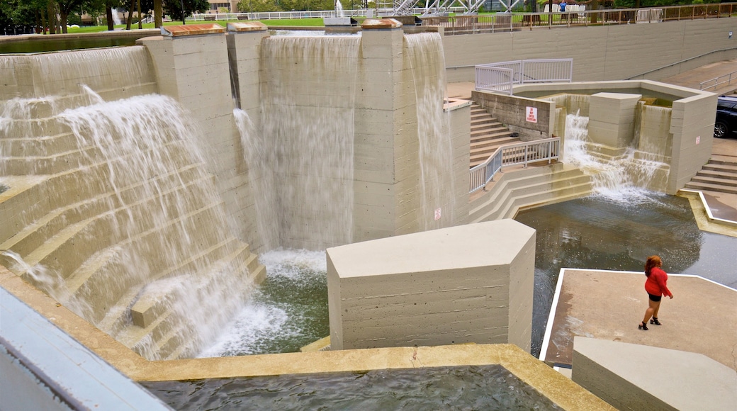 Downtown Rochester featuring a fountain as well as an individual female