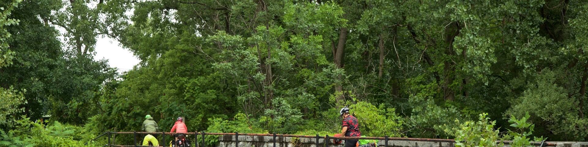 Old Erie Canal Historic State Park which includes a bridge and a park as well as a small group of people