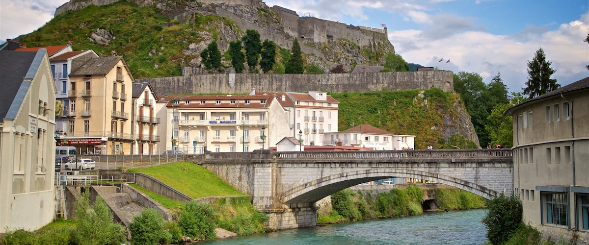Chateau Fort Pyreneen Museum featuring a river or creek, a bridge and heritage architecture