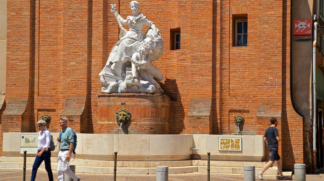 Toulouse featuring a statue or sculpture and a fountain as well as a couple