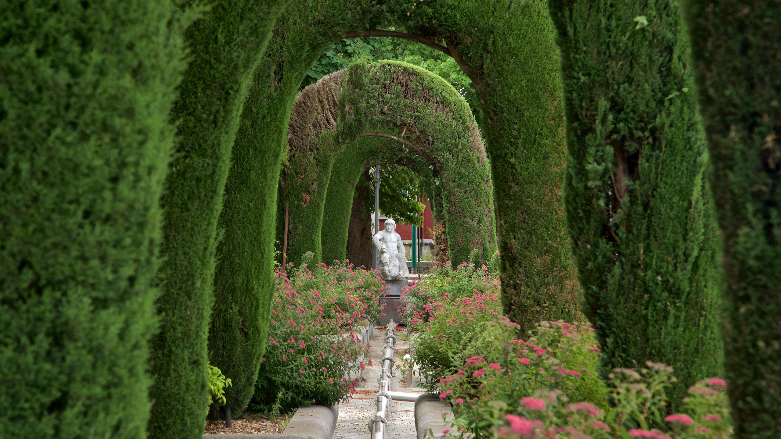 Lourdes - Tarbes featuring a statue or sculpture, a garden and wildflowers