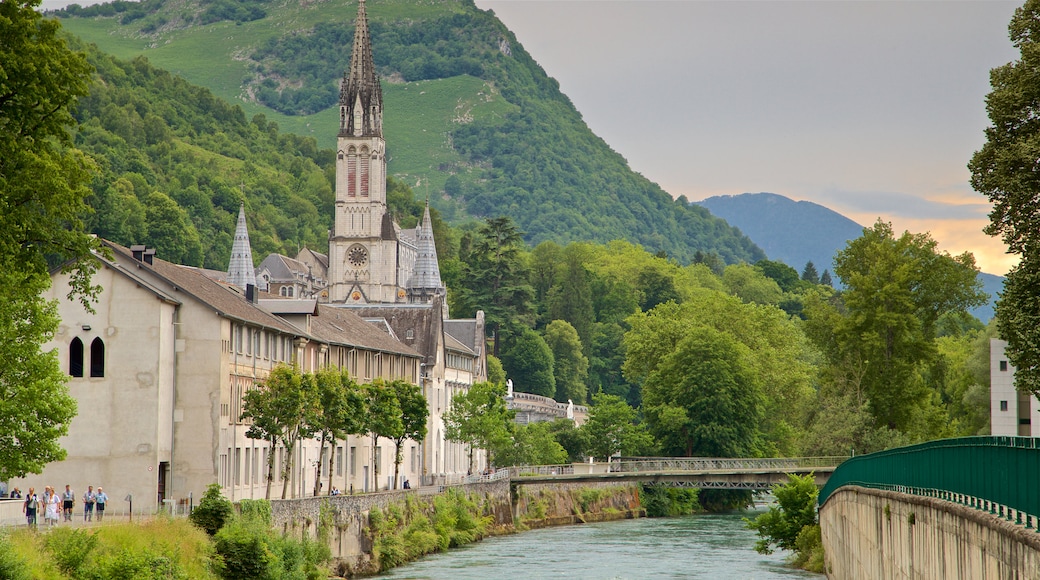 Lourdes-Tarbes mostrando arquitetura de patrimônio, uma igreja ou catedral e um rio ou córrego