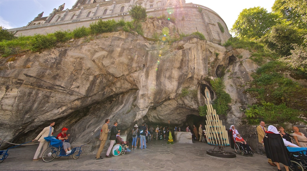 Grotte of Massabielle which includes religious elements as well as a small group of people