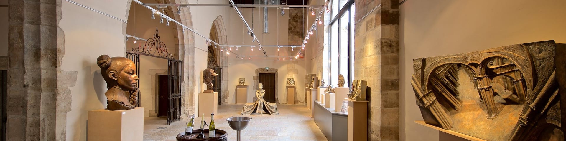 Marche Aux Vins Winery which includes interior views, a statue or sculpture and art