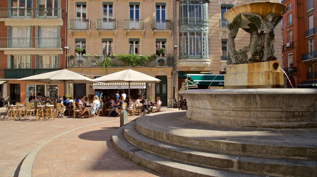 Esquirol Place showing outdoor eating and a fountain as well as a small group of people