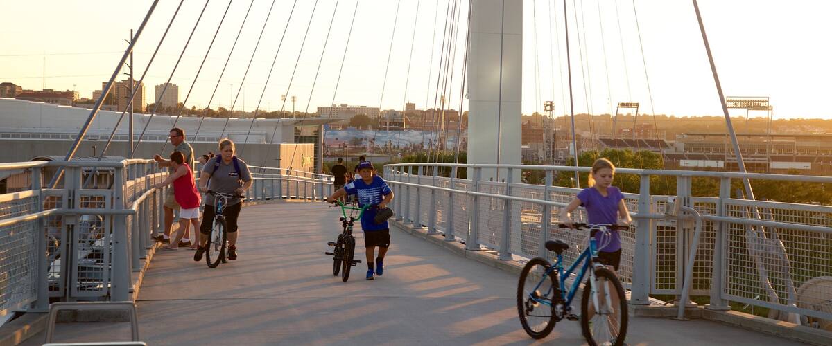 Bob Kerrey Pedestrian Bridge which includes cycling, a bridge and a sunset