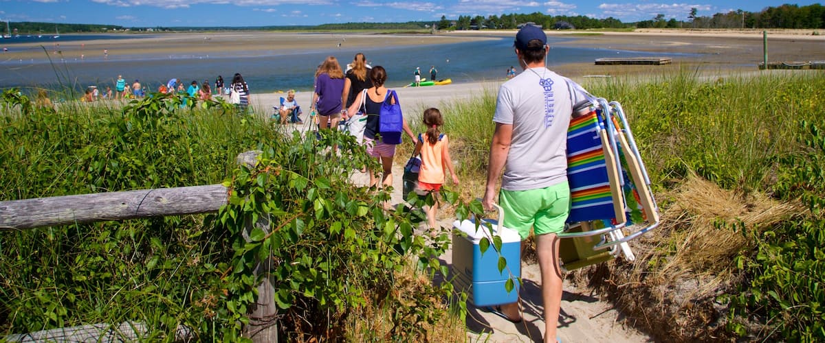 Scarborough featuring general coastal views and a sandy beach as well as a family
