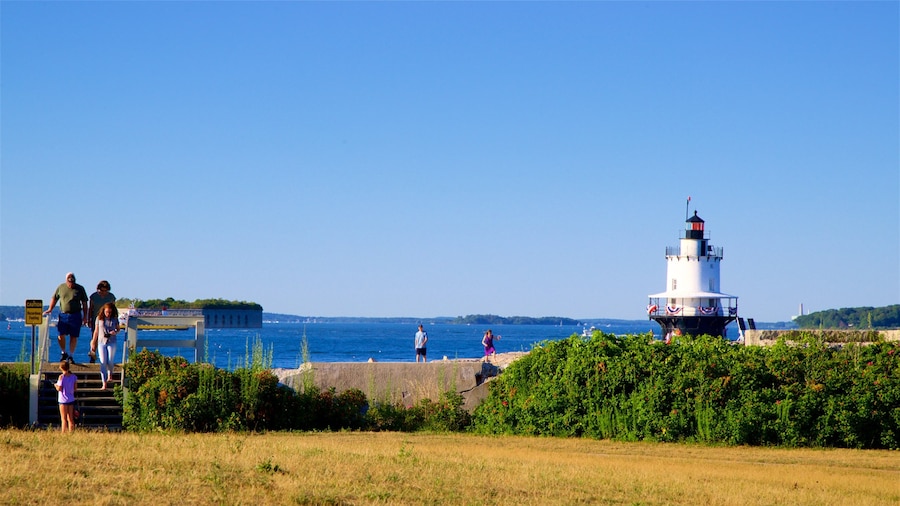 Fort Preble showing a garden and a lighthouse as well as a small group of people