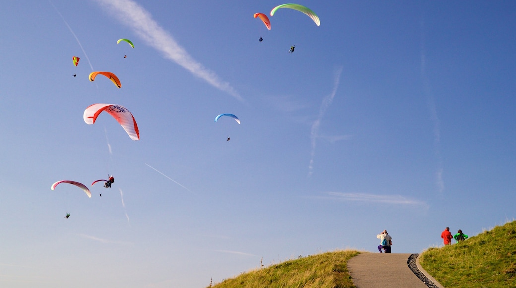 Puy de Dome showing landscape views and parachuting as well as a small group of people