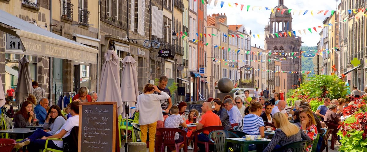 Riom which includes a city, outdoor eating and signage