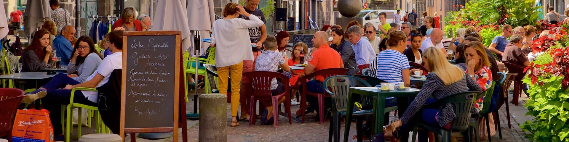 Riom which includes a city, outdoor eating and signage