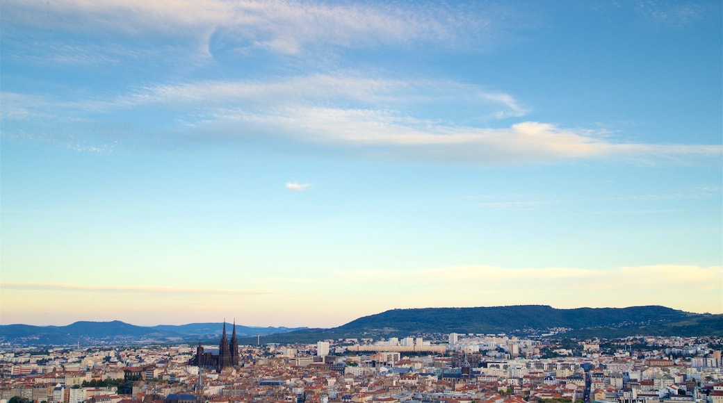 Montjuzet Park showing a sunset, a city and a church or cathedral