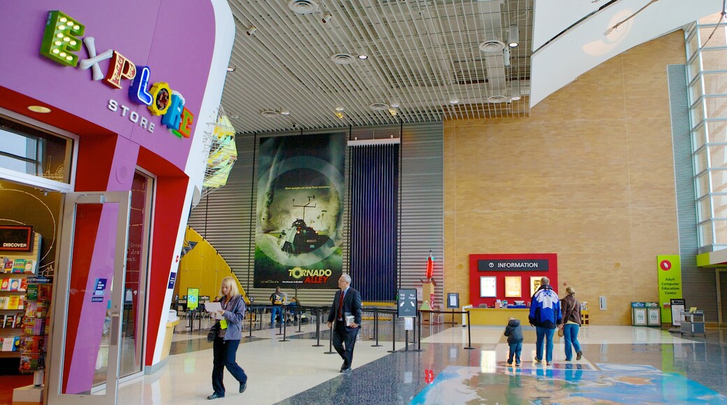 Science Museum of Minnesota featuring interior views and signage as well as a family