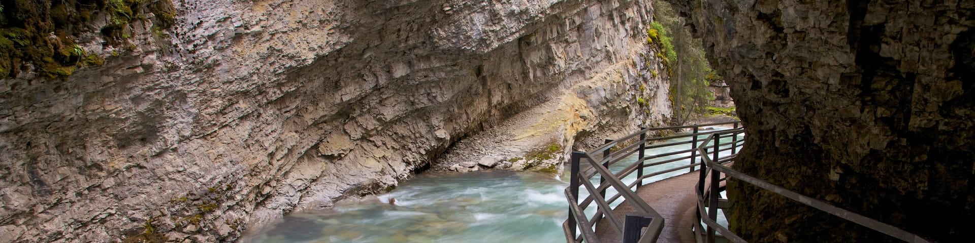 Johnston Canyon featuring a river or creek, rapids and landscape views