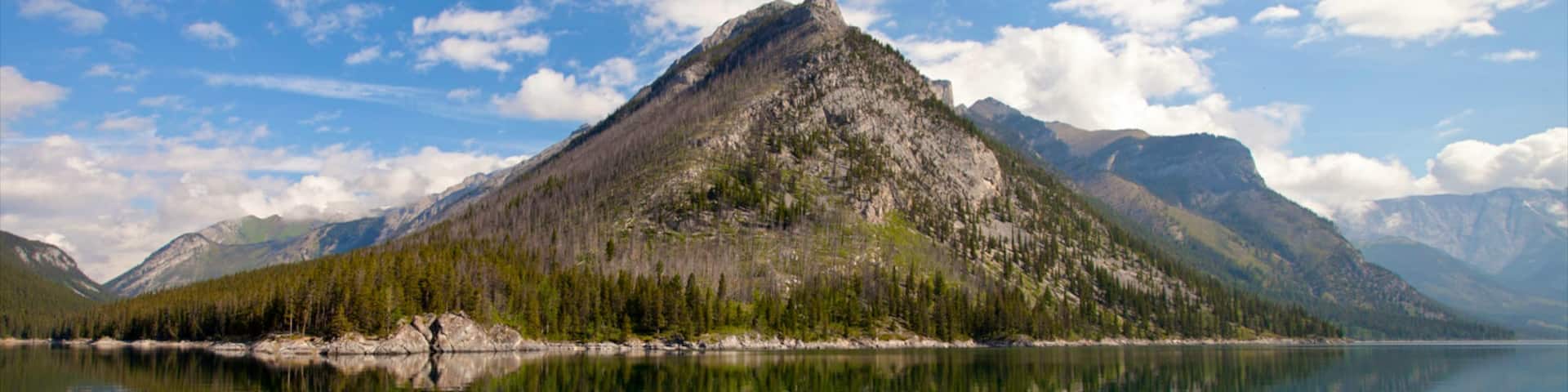 Lake Minnewanka featuring landscape views and mountains