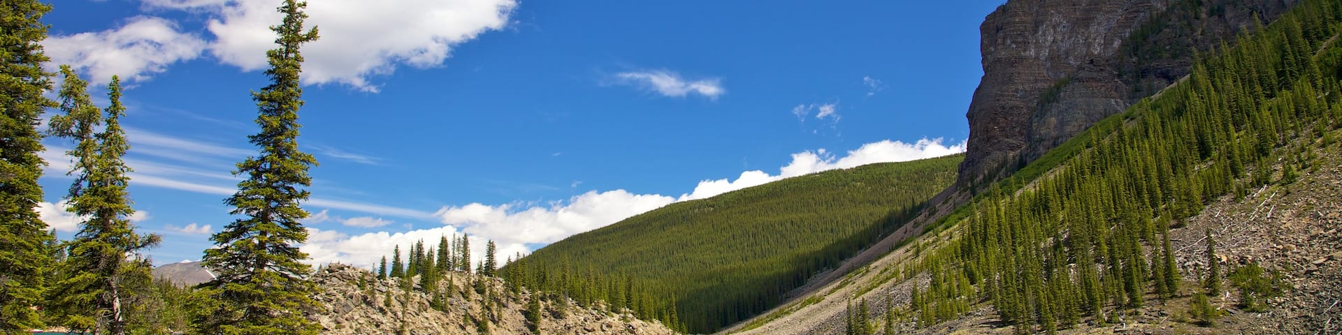 Lake Minnewanka featuring a lake or waterhole, kayaking or canoeing and mountains