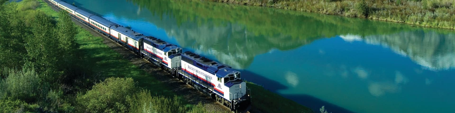 Banff National Park which includes railway items, a lake or waterhole and mountains