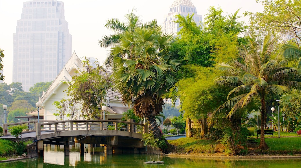 Parque Lumpini que incluye un puente, un jardín y una ciudad