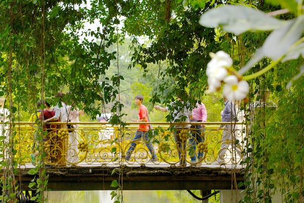 Vimanmek Palace which includes heritage architecture, a garden and a lake or waterhole