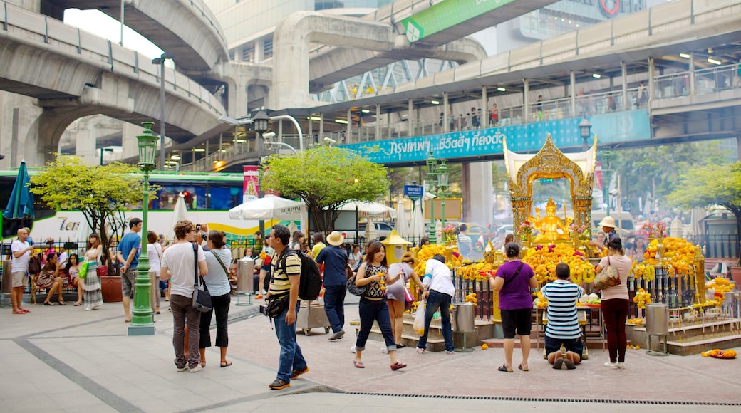 Bangkok City Centre showing religious elements and a square or plaza as well as a small group of people