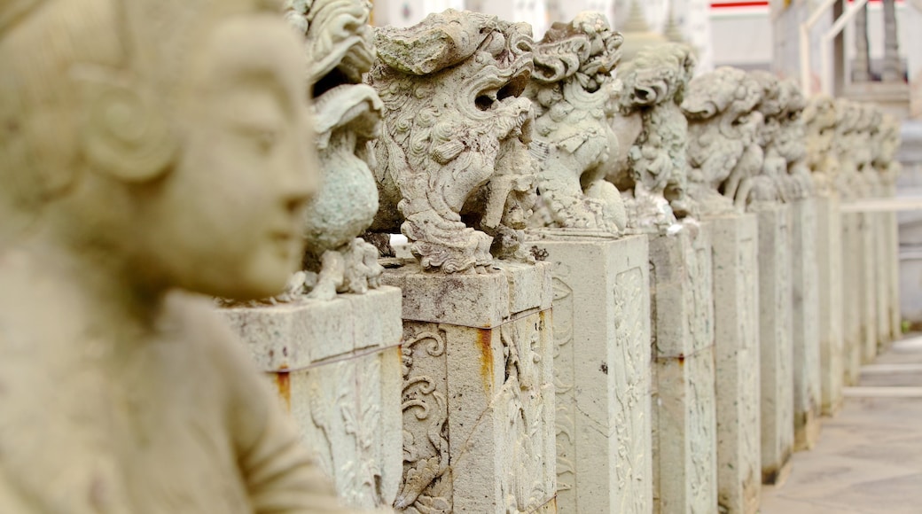 Wat Arun showing religious elements, a monument and a statue or sculpture