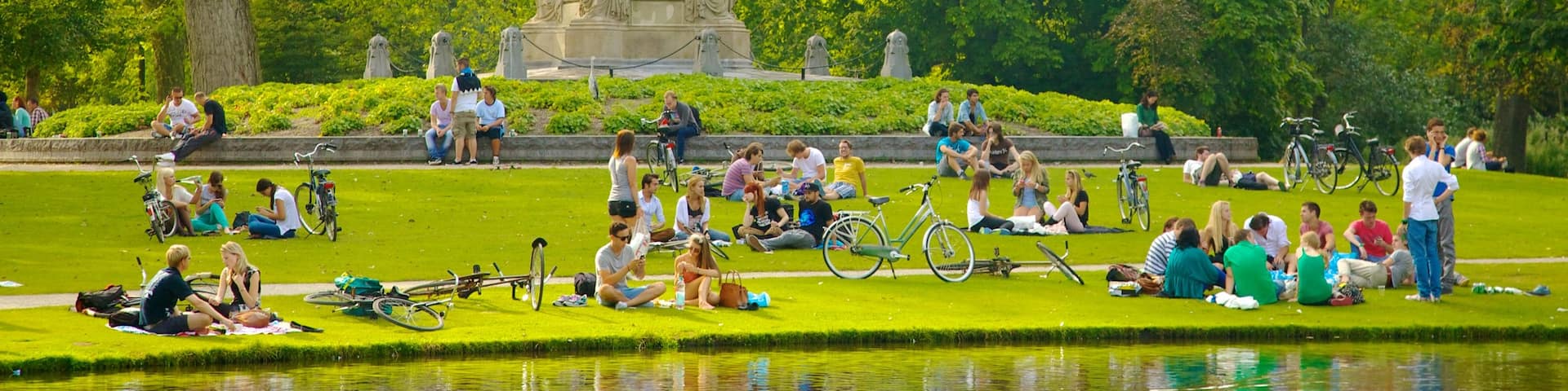 Vondelpark featuring a pond, landscape views and a statue or sculpture