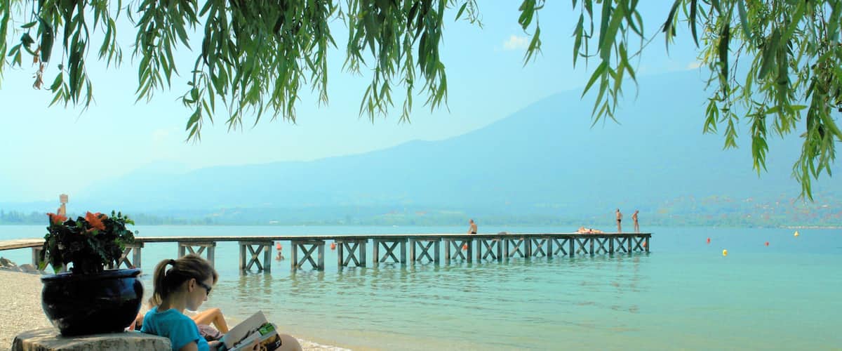 Aix-les-Bains which includes landscape views and a sandy beach as well as an individual female