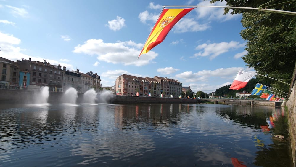 Epinal which includes landscape views, heritage architecture and a river or creek