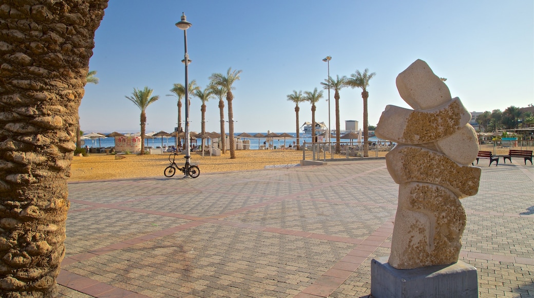 Green Beach which includes outdoor art, a square or plaza and a coastal town