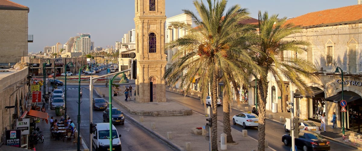 Jaffa Clock Tower which includes heritage architecture, a city and a sunset