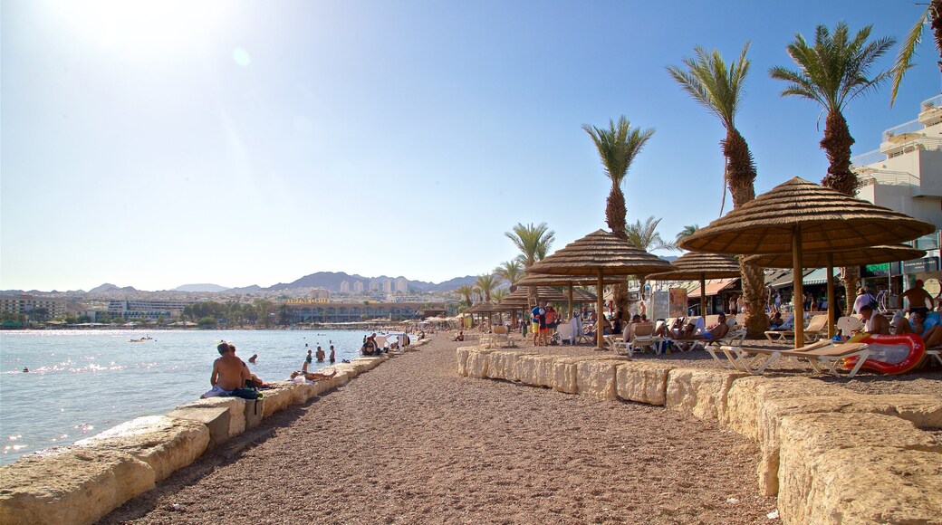 Green Beach which includes a sandy beach and general coastal views as well as a small group of people