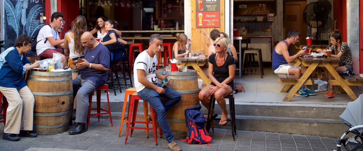 Carmel Market showing cafe scenes and outdoor eating as well as a couple