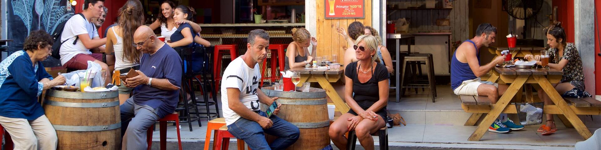 Carmel Market showing cafe scenes and outdoor eating as well as a couple