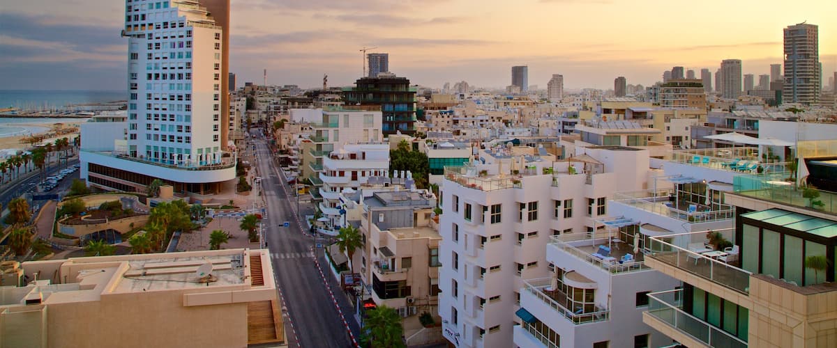 Frishman Beach featuring a coastal town, a city and a sunset