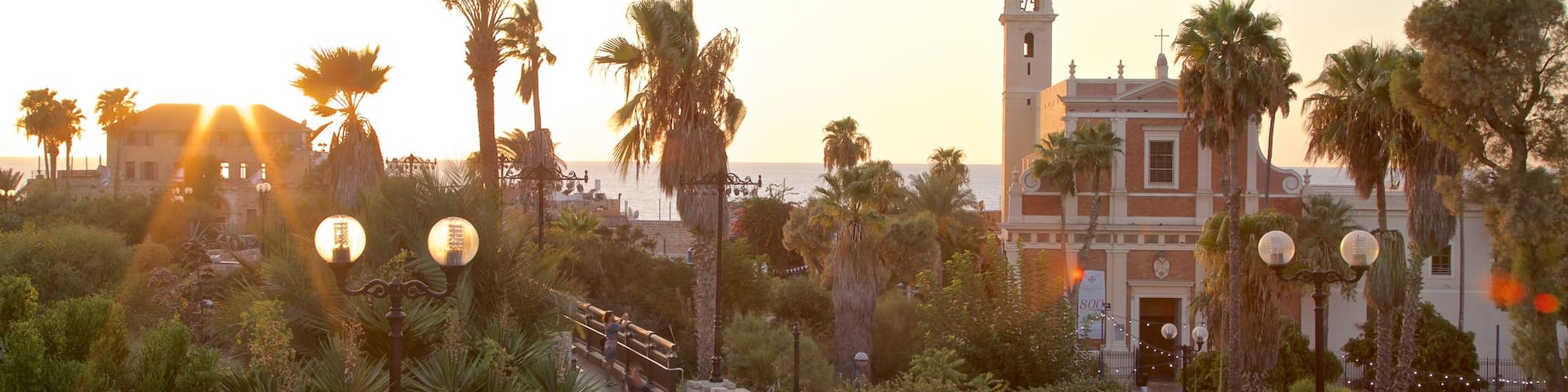 Church of St. Peter featuring a sunset, a church or cathedral and a garden