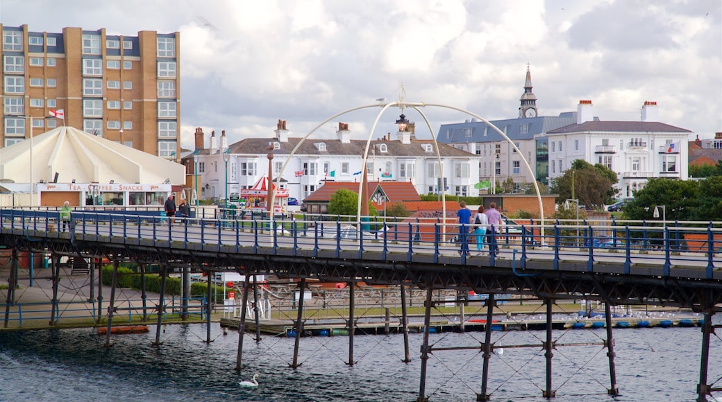 Southport Pier featuring a bridge and a river or creek as well as a small group of people