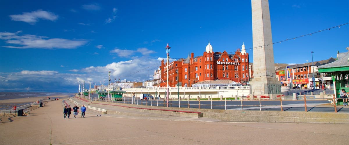 Blackpool North Shore Beach featuring a monument as well as a small group of people