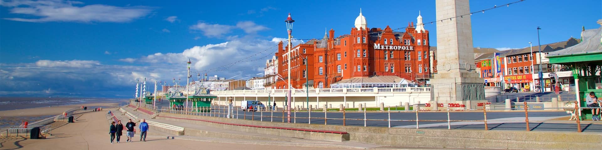 Blackpool North Shore Beach showing a monument as well as a small group of people