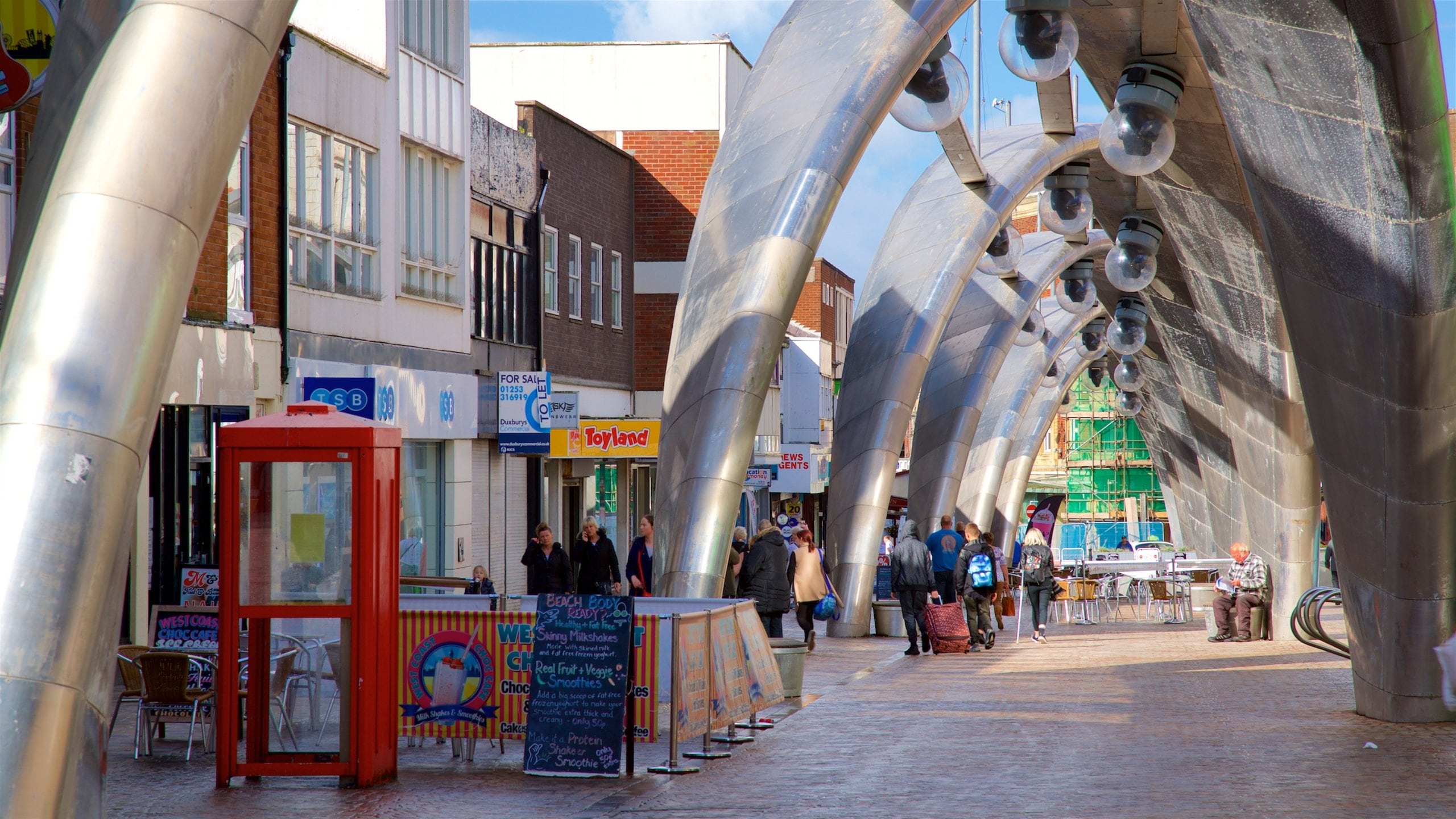 Blackpool featuring outdoor art and street scenes as well as a small group of people