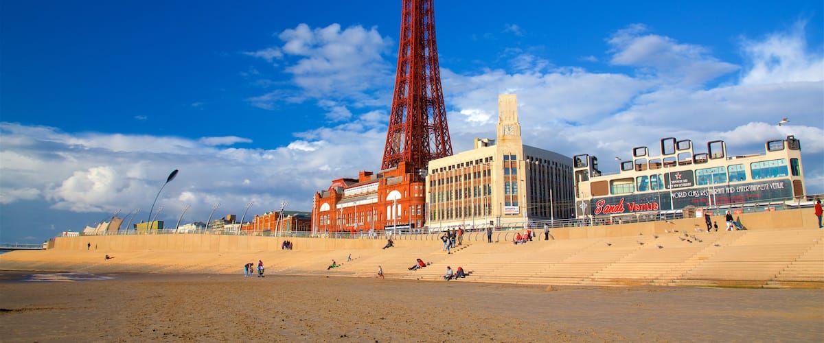 Blackpool Tower featuring general coastal views, a sandy beach and a coastal town