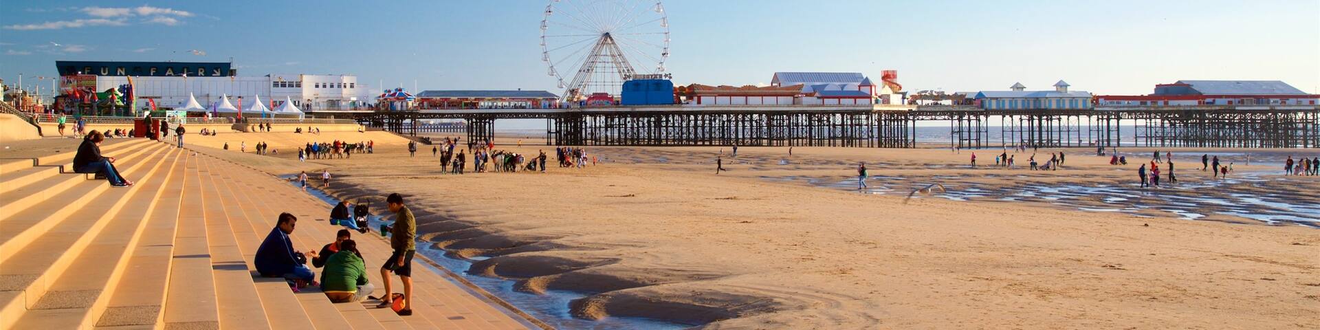 Blackpool Beach showing a beach and general coastal views as well as a small group of people