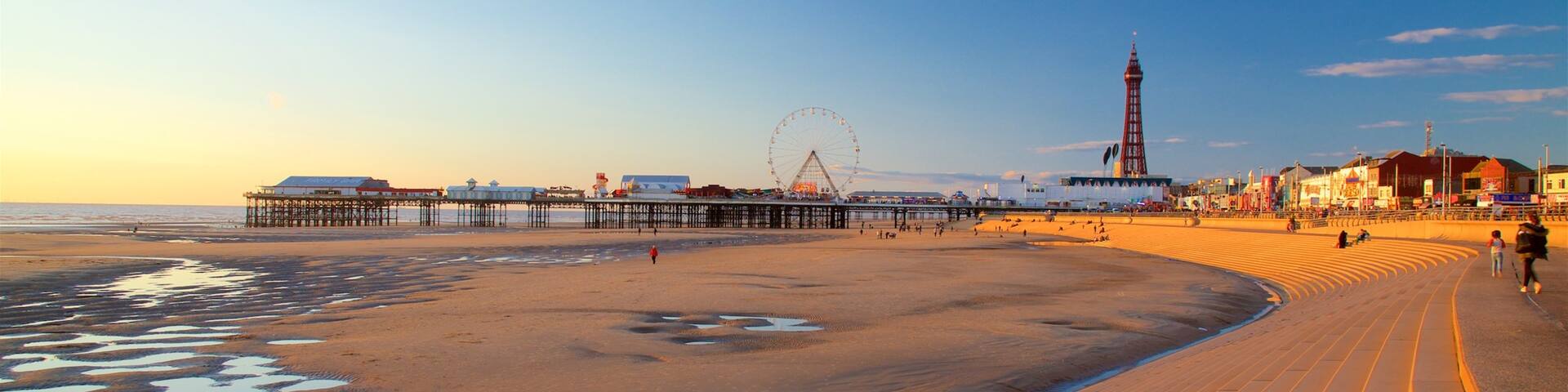Blackpool Central Pier showing a sandy beach, a sunset and general coastal views