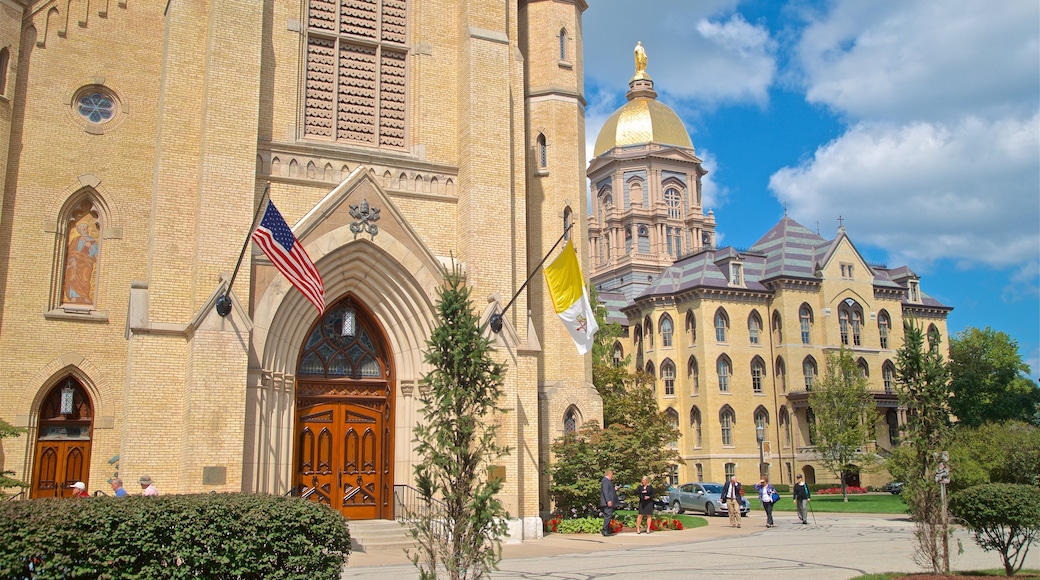 Basilica of the Sacred Heart featuring a church or cathedral and heritage architecture as well as a small group of people