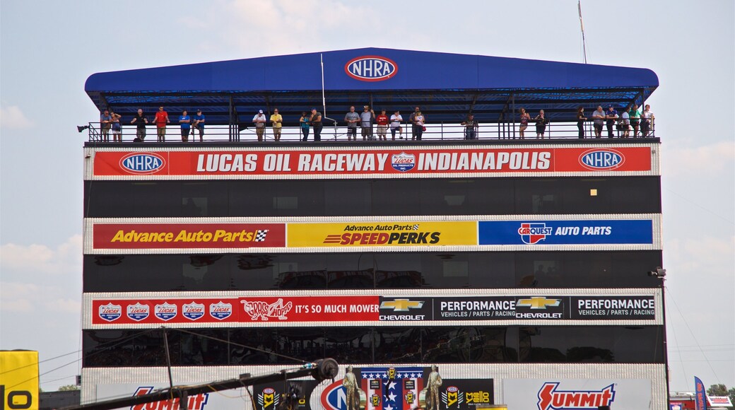 Lucas Oil Raceway which includes signage as well as a small group of people