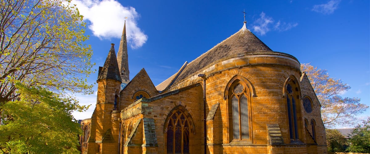Church of the Holy Sepulchre which includes autumn colours, a cemetery and a church or cathedral