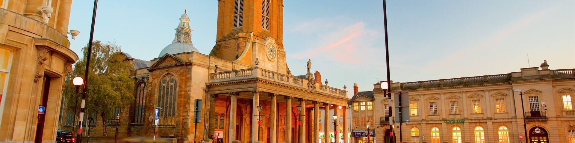 All Saints Church featuring a sunset, a city and heritage architecture