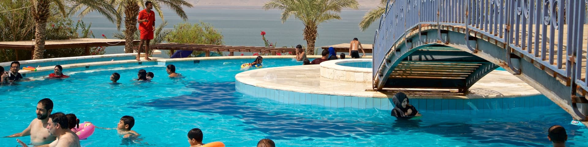 Sweimeh which includes general coastal views, a pool and swimming