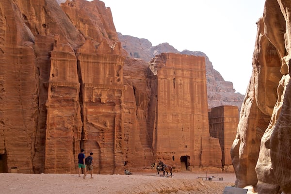 Street of Facades featuring heritage elements and a gorge or canyon as well as a small group of people