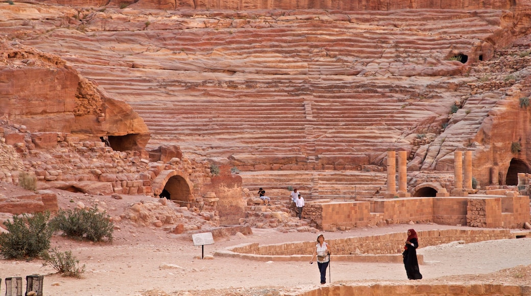 Nabatean Theater featuring building ruins and heritage elements as well as a small group of people