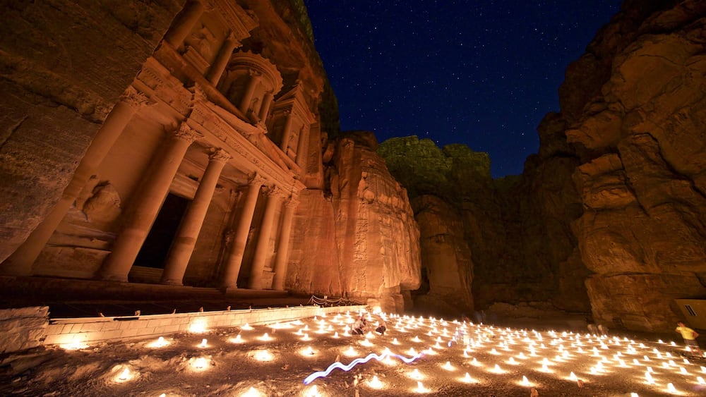 Wadi Musa which includes heritage architecture, night scenes and a gorge or canyon